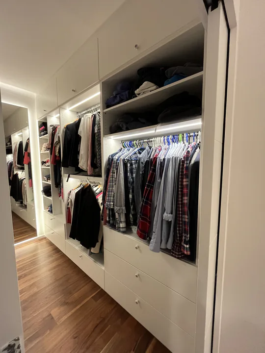 Begehbarer Kleiderschrank mit beleuchteten Fachböden und Kleiderstangen